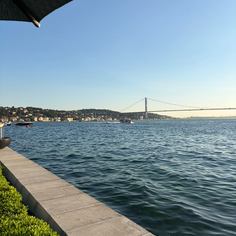 A quiet waterside terrace on the Bosphorus in Istanbul, with the bridge in the distance